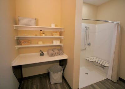 Assisted Living Bathroom with Wheelchair Accessible Shower, decor and folded linen